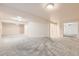 Expansive living room with plush gray carpeting and ample natural light, perfect for relaxation and entertainment at 270 Terra Vista St, Brighton, CO 80601