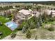 An aerial view showcasing a home, basketball court, and expansive landscape at 10010 Steeplechase Dr, Franktown, CO 80116