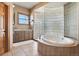 Bathroom boasts a large soaking tub and glass block shower at 10010 Steeplechase Dr, Franktown, CO 80116