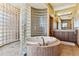 Spa-like bathroom with a large glass block shower and soaking tub at 10010 Steeplechase Dr, Franktown, CO 80116