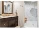 Bathroom with walk-in shower and dark vanity at 10010 Steeplechase Dr, Franktown, CO 80116