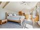 Bright bedroom featuring a wooden bed frame and ample sunlight at 10010 Steeplechase Dr, Franktown, CO 80116