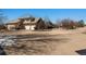 House exterior with large driveway and landscaping at 10010 Steeplechase Dr, Franktown, CO 80116