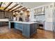 Spacious kitchen with a large island and exposed beam ceiling at 10010 Steeplechase Dr, Franktown, CO 80116