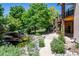 Landscaped backyard with pond, waterfall and pathway at 10010 Steeplechase Dr, Franktown, CO 80116