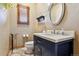 Elegant powder room with dark vanity, vessel sink, and decorative mirror at 10010 Steeplechase Dr, Franktown, CO 80116