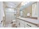 Bathroom with a glass-enclosed shower, neutral-toned tiles, and vanity at 775 Woodgate Dr, Highlands Ranch, CO 80126