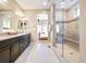 Modern bathroom with dual sink vanity, and glass enclosed shower with built in bench seating at 775 Woodgate Dr, Highlands Ranch, CO 80126