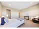 Cozy bedroom with a comfortable bed, rocking chair, and ample space at 775 Woodgate Dr, Highlands Ranch, CO 80126
