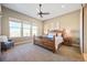 Comfortable bedroom featuring large windows, a ceiling fan, and a decorative headboard at 775 Woodgate Dr, Highlands Ranch, CO 80126