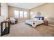 Serene bedroom featuring a comfortable bed, rocking chair, and lots of natural light at 775 Woodgate Dr, Highlands Ranch, CO 80126
