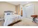 Inviting bedroom with a cozy bed, classic furniture, and closet with doors open at 775 Woodgate Dr, Highlands Ranch, CO 80126