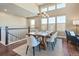 Bright dining room featuring a chandelier, lots of natural light, and views of the second-floor balcony at 775 Woodgate Dr, Highlands Ranch, CO 80126
