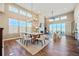 Open concept dining room with high ceilings, large windows, modern lighting, and hardwood floors at 775 Woodgate Dr, Highlands Ranch, CO 80126