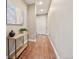 Hallway with engineered wood flooring, decorated with modern artwork and table decor at 775 Woodgate Dr, Highlands Ranch, CO 80126