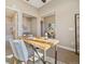 Bright home office space with large windows, a work desk, and neutral tones at 775 Woodgate Dr, Highlands Ranch, CO 80126