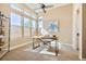 Bright office space with large windows, a work desk, and a comfortable seating area at 775 Woodgate Dr, Highlands Ranch, CO 80126
