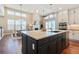 An open-concept kitchen with a large island, stainless steel appliances, and lots of natural light at 775 Woodgate Dr, Highlands Ranch, CO 80126