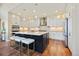 Bright kitchen with white cabinets, stainless steel appliances, and a large island with seating at 775 Woodgate Dr, Highlands Ranch, CO 80126
