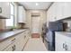Spacious laundry room with modern washer and dryer, lots of counter space and storage cabinets at 775 Woodgate Dr, Highlands Ranch, CO 80126