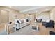 Cozy living room with neutral tones, comfortable seating, and a staircase in the background at 775 Woodgate Dr, Highlands Ranch, CO 80126
