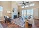 Inviting living room featuring a fireplace, high ceilings, and sliding glass doors to a balcony at 775 Woodgate Dr, Highlands Ranch, CO 80126