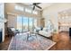 A well-lit living room with an open floor plan, patio access, and hardwood floors at 775 Woodgate Dr, Highlands Ranch, CO 80126