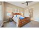 Cozy bedroom with sliding barn door leading to the bathroom and a carved wood bed frame at 775 Woodgate Dr, Highlands Ranch, CO 80126