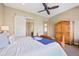 Bedroom featuring a carved wood bed frame, white sliding door, and wooden dresser at 775 Woodgate Dr, Highlands Ranch, CO 80126