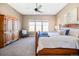 Bedroom with a carved wood bed frame, cozy armchair and scenic views at 775 Woodgate Dr, Highlands Ranch, CO 80126