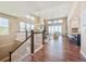 Open floorplan with hardwood floors, large windows, and a spacious living area and kitchen at 775 Woodgate Dr, Highlands Ranch, CO 80126