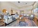 Open floorplan with hardwood floors, large windows, and a spacious living area and kitchen at 775 Woodgate Dr, Highlands Ranch, CO 80126
