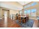 Bright dining area with hardwood floors, large windows, and a stylish rug at 775 Woodgate Dr, Littleton, CO 80126