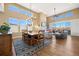 Inviting dining room featuring large windows, a modern chandelier, and an adjacent sitting area at 775 Woodgate Dr, Littleton, CO 80126