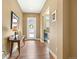 Welcoming foyer with hardwood floors, console table, and view into adjacent living spaces at 775 Woodgate Dr, Littleton, CO 80126