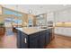 Beautiful kitchen island with stainless steel dishwasher and sink overlooking the living and dining areas at 775 Woodgate Dr, Littleton, CO 80126