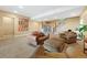 Inviting carpeted living room features a staircase, a bookshelf, and comfortable seating, perfect for relaxation and entertaining at 775 Woodgate Dr, Littleton, CO 80126