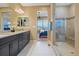 Beautiful bathroom featuring double vanity, black cabinets, and glass enclosed shower at 775 Woodgate Dr, Littleton, CO 80126