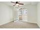 A bright bedroom with a ceiling fan and shuttered doors at 1950 N Logan St # 102, Denver, CO 80203