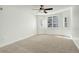 A bright bedroom with a ceiling fan and windows with shutters at 1950 N Logan St # 102, Denver, CO 80203