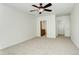 A bright bedroom with a ceiling fan, carpet, and an attached bathroom at 1950 N Logan St # 102, Denver, CO 80203