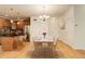 Bright dining area adjacent to kitchen with hardwood floors, modern lighting, and a seating area at 1950 N Logan St # 102, Denver, CO 80203