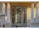 Elegant front door with symmetrical sidelights and decorative pillars, enhancing the home's curb appeal at 1950 N Logan St # 102, Denver, CO 80203