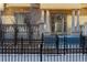 Charming front entrance with black iron fence, stone pathway, and a stately door flanked by decorative columns at 1950 N Logan St # 102, Denver, CO 80203