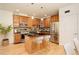 Spacious kitchen featuring stainless steel appliances, wood cabinets, an island with seating, and hardwood floors at 1950 N Logan St # 102, Denver, CO 80203
