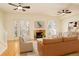 Bright living room with hardwood floors, a stone fireplace, and french doors with plantation shutters at 1950 N Logan St # 102, Denver, CO 80203