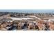 Beautiful aerial view of a neighborhood with snow-dusted roofs and expansive open spaces, showcasing community living at 9581 Firenze Way, Highlands Ranch, CO 80126