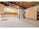 Unfinished basement features storage cabinets and open ceiling, offering great potential at 9581 Firenze Way, Highlands Ranch, CO 80126