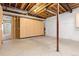 Unfinished basement area with sturdy wooden cabinets and exposed ceiling beams at 9581 Firenze Way, Highlands Ranch, CO 80126