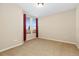 Neutral room offers a bright window with red curtains and carpeted flooring at 9581 Firenze Way, Highlands Ranch, CO 80126